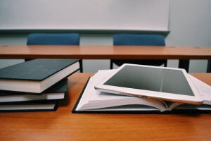 financial education tablet and books on a desk