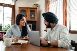 Couple sitting at desk funeral planning