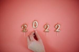 Numbered candles for 2022 on pink background