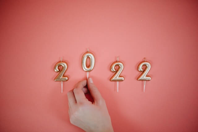 Numbered candles for 2022 on pink background