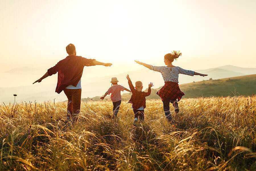 Family running through a field